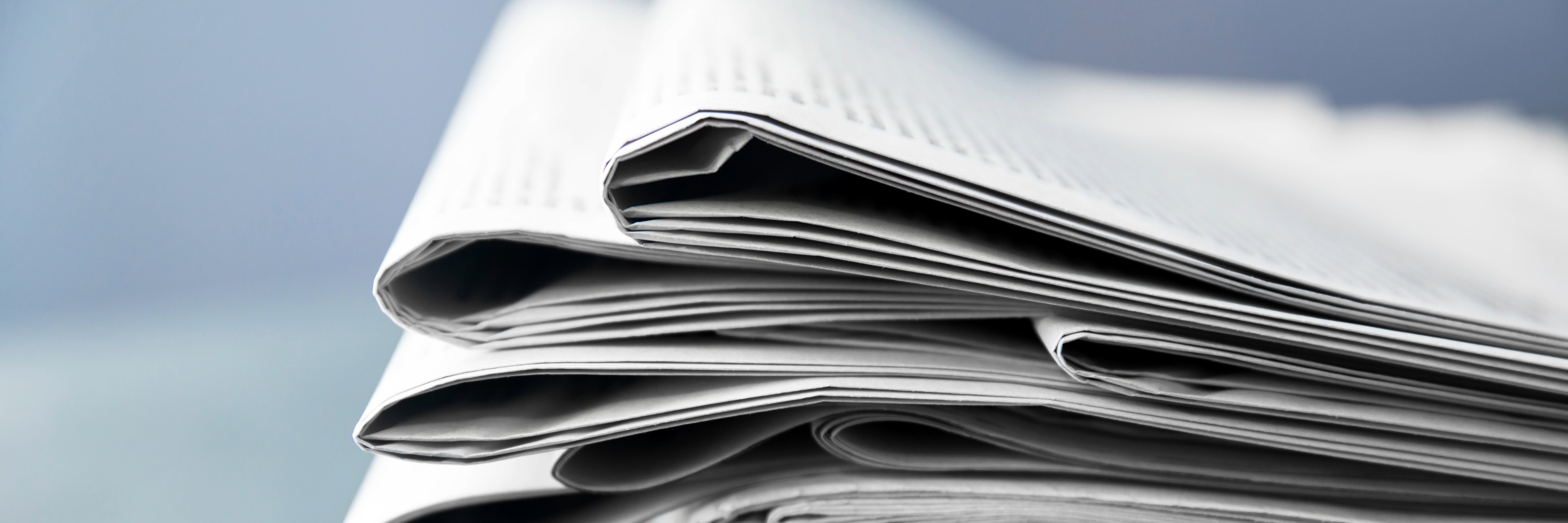 Nahaufnahme eines gefalteten Zeitungsstapels mit sichtbaren Papierkanten